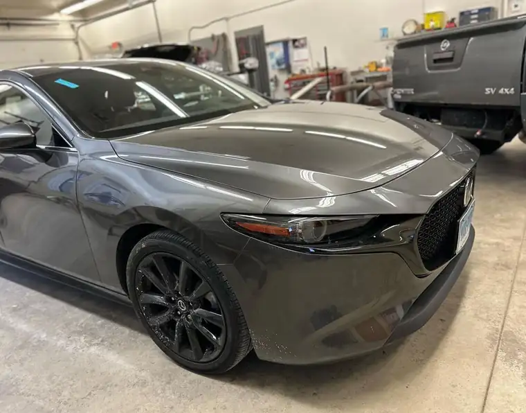 The same grey Mazda3 with its front end repaired