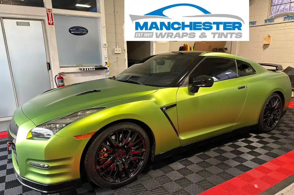 A satin green wrapped Nissan GT-R in the Manchester Wraps & Tints bay
