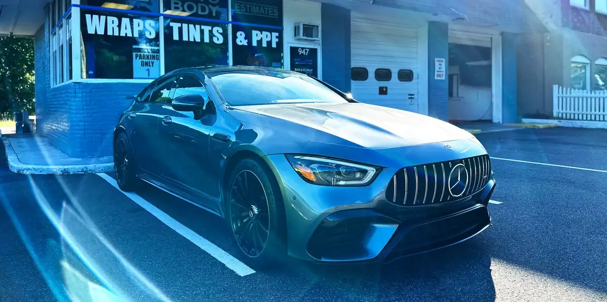 A Mercedes-AMG GT parked outside the Manchester Wraps & Tints storefront at 947 Center St